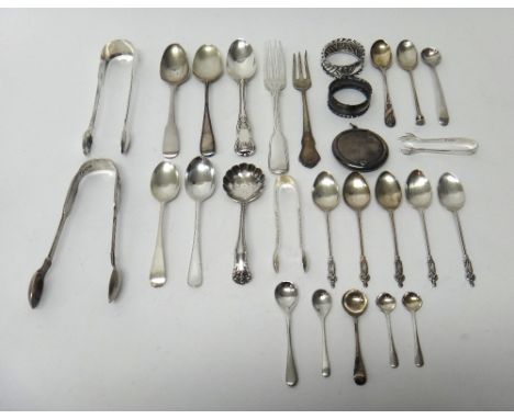 Silver, comprising; two napkin rings, four pairs of sugar tongs, a sugar sifting spoon, five figure terminal teaspoons, six c
