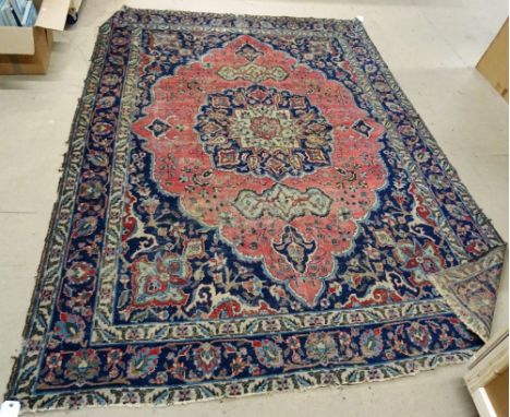 A Hamadan carpet, first half 20th century, with pink lozenge shaped field and blue medallion, 231cm x 327cm, (a.f).