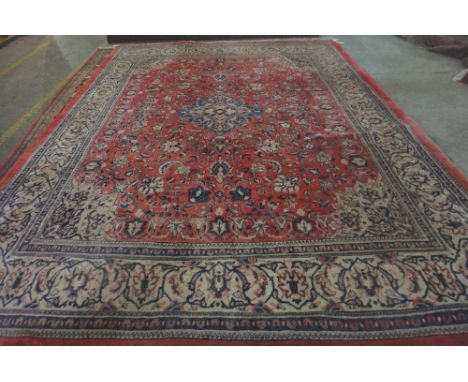 A Mahal carpet, Persian, the madder field with a pale indigo diamond, fawn spandrels, all with palmettes and floral vine spra