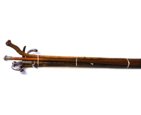 An early 20th century hazel walking stick, with a white metal handle, 83cm long, an unusual horn walking stick, late 19th cen