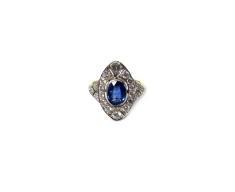 A heat treated sapphire and diamond set oval panel shaped cluster ring, collet set with the heat treated oval cut sapphire in