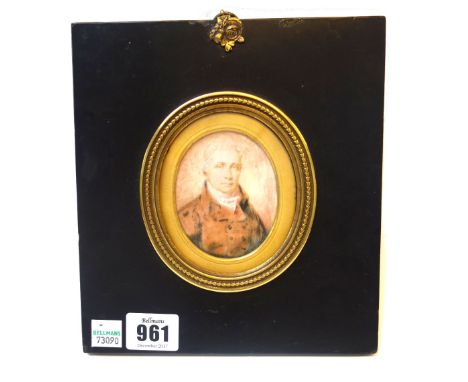 A portrait miniature on plaster, by Mr. J Newton, circa 1815, depicting a gentleman in a button coat, framed and glazed, writ