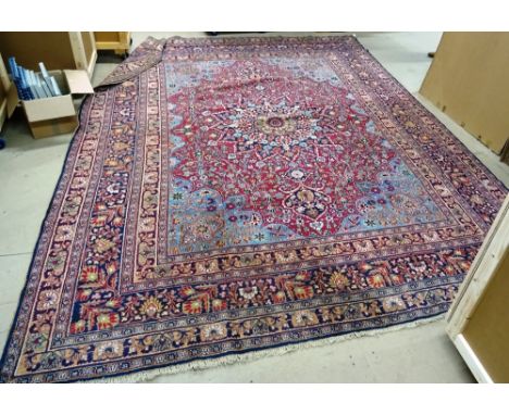 A Doroksh carpet with plum field and central medallion, light blue spandrels and banded border, 320cm x 412cm. 