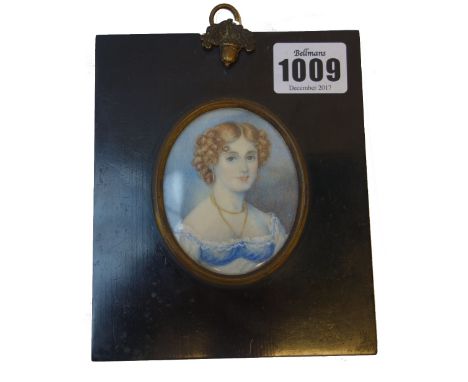 A mid-19th century English School portrait miniature on ivory of 'Miss Danby', her hair in ringlets, with gold necklace and w