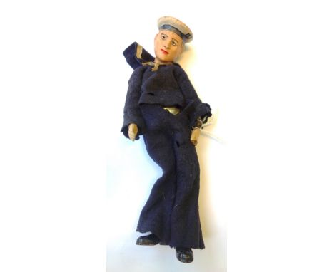 An unusual Swiss sailor doll, early/mid 20th century, with painted ceramic head and hands, and a ball and socket jointed meta