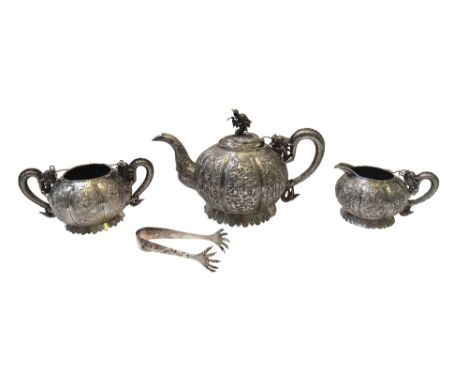 A Chinese three piece tea set, comprising; a teapot, a twin handled sugar bowl and a milk jug, each piece decorated with a se