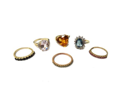 A 9ct gold and sapphire set nine stone half hoop eternity ring, a 9ct gold and ruby set ten stone half hoop eternity ring and