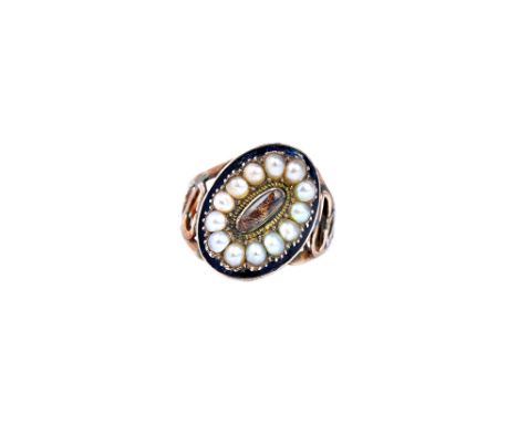 A gold, half pearl set and black enamelled mourning ring, glazed with an oval hair locket compartment at the centre, in a sur