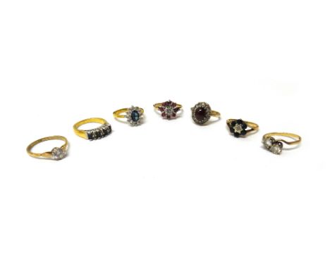 A 9ct gold, sapphire and diamond seven stone cluster ring, a 9ct gold, ruby and diamond nine stone cluster ring, a 9ct gold a