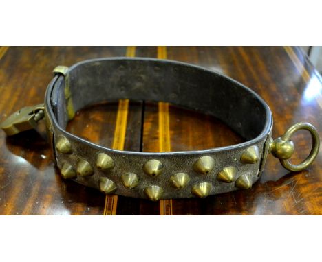 A 19th century French leather hunting-dog collar with brass ring, studs and padlock, plaque engraved 'Tommie, Policard, 12 R.