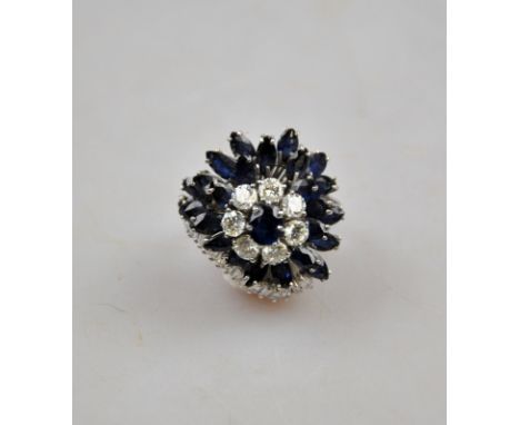 Large handmade freeform cocktail ring set with brilliant and baguette cut diamonds and marquise cut sapphires of good colour,