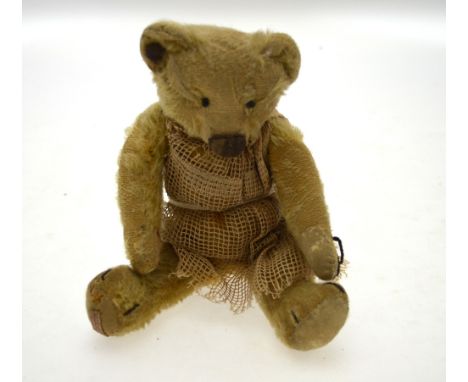 A Chad Valley teddy bear with worn mohair, stud to ear, stitched eyes, nose, mouth and claws, felt pads (one replacement), 28