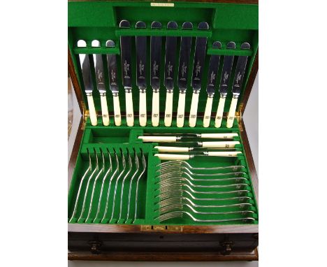 An oak canteen fitted with a set of OEP silver flatware for nine, comprising dessert knives and forks, dessert spoons, six so