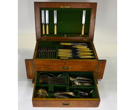 An oak canteen containing a mostly complete set of electroplated Old English Pattern flatware with cutlery and some matching 