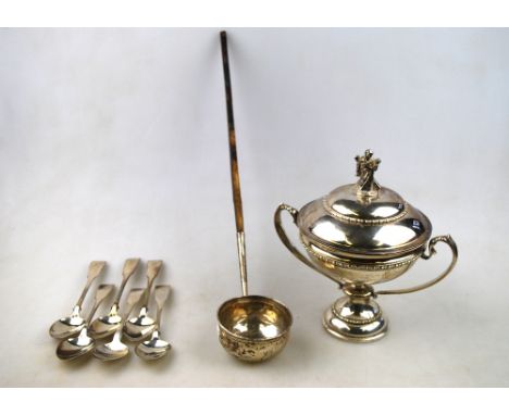 A silver chalice and cover, surmounted by the figure of St. Andrew, with twin scroll handles and stemmed foot, London 1937, 9