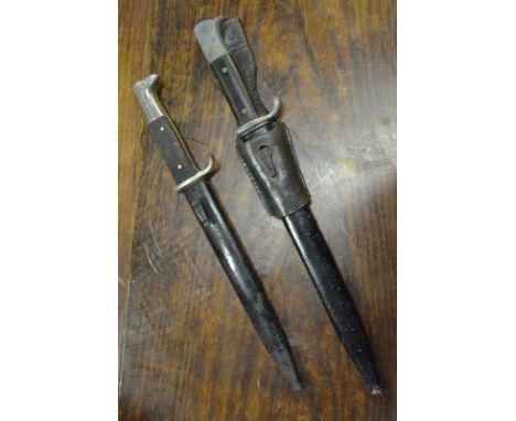A WWII German small pattern dress bayonet with 25 cm electroplated fullered blade, two piece wood grip and bird's had pommel,