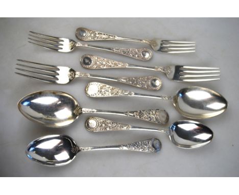 An extensive late Victorian set of silver flatware with ornately chased handles, comprising: 18 table forks, 18 dessert spoon