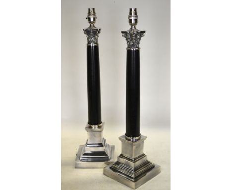 A pair of classical style electroplated and black stone column lamp-bases, 58 cm