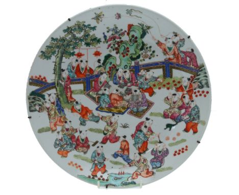 A Chinese 19th century famille rose charger decorated with the Wa Wa pattern - children playing on a terrace beneath a pine t