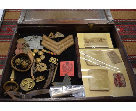 Assorted 19th/20th century militaria including brass helmet spike and link chin strap, Royal Berkshire Regiment insignia, dog