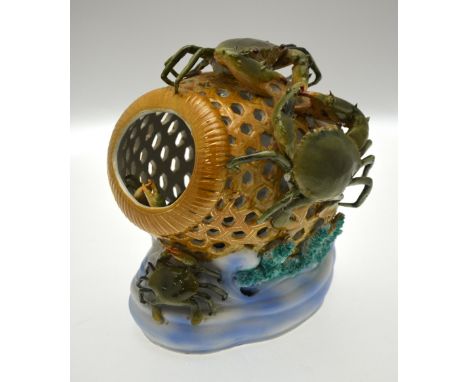 A Continental porcelain lamp in the form of a crab pot decorated in relief with crabs inside and outside, 26.5 cm high Condit