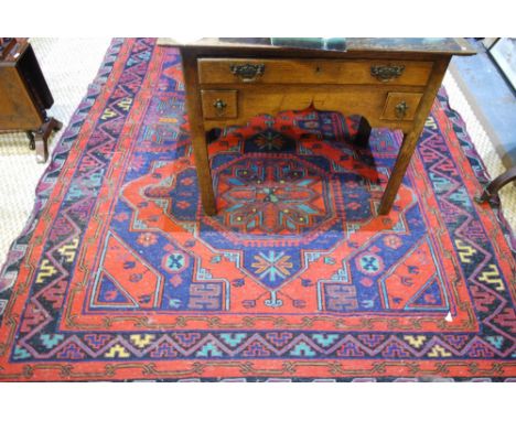 An old Persian Sumak carpet of kelleigh proportions, the blue geometric design on red ground, 3.17 x 1.85 m Condition Report 