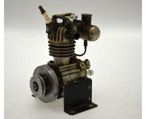 An engineers scale model four stroke single cylinder side valve engine with side mounted fuel tank, raised on a bolt down sta