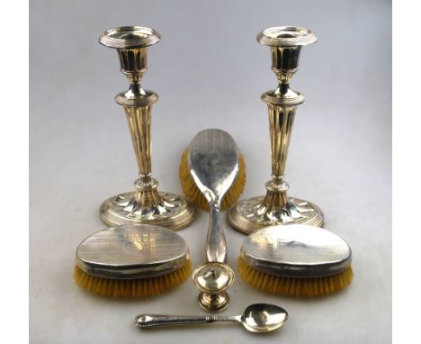 A pair of Edwardian Adam revival oval loaded silver candlesticks with fluted columns, Sheffield 1905, 26 cm, to/w a pair of e