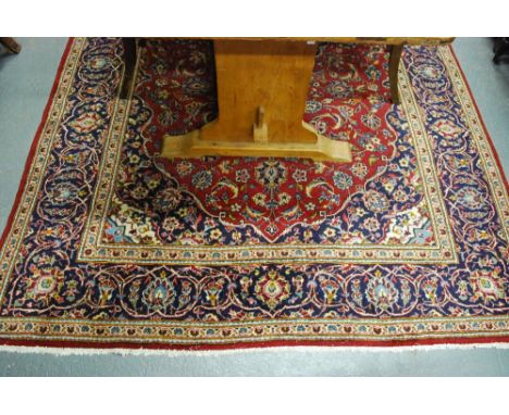 A Persian Meshed carpet, 2nd half 20th century, the blue ground with centre medallion design on red ground, 2.90 x 1.95 m Con
