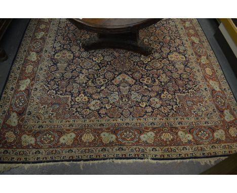 A Persian Kashan carpet, 1st quarter 20th century, the blue ground centred with a stylised floral medallion in pale green, re