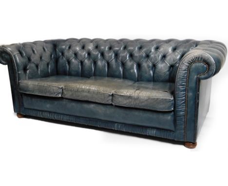 A Victorian style Chesterfield settee, in blue leather, with button back and arms and detachable cushions, on compressed bun 