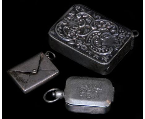 An Edwardian silver stamp case, of envelope form with ring side, Birmingham 1901, 3cm W, an unmarked seal case, repoussé deco