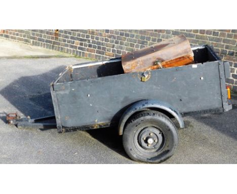 A single axle trailer, with metal mount, two wheels, with wooden side, the main section 92cm W, 152cm D, a tin trunk and spar