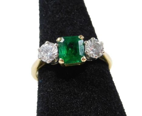 An late 20thC 18ct gold emerald and diamond ring, with central square cut emerald measuring 6mm x 5.8mm x 3.4mm, approx 0.74c