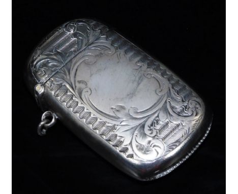 A Victorian silver vesta case, of oblong form, chased with scrolls and a geometric pattern, with match strike base and ring s