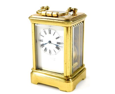 A 20thC miniature gilt brass carriage clock, of rectangular form with swing handle, five piece glass case with open movement,