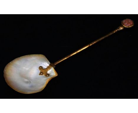 A 19thC spoon, with nacre shell bowl, turned handle and moonstone set head, impressed with an oval figure, unmarked, 23cm H.