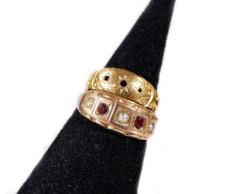 Two gypsy rings, comprising one set with garnet and seed pearl, yellow metal, unmarked, ring size T, and a 9ct gold example, 