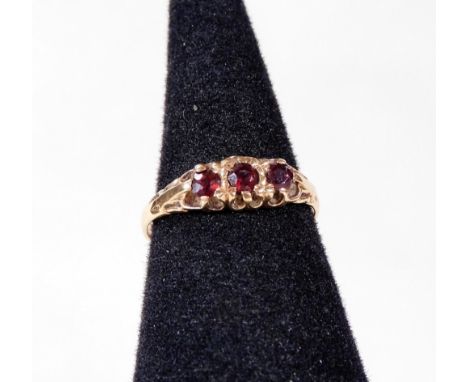 A 9ct gold dress ring, set with three garnet stones, each in claw setting, ring size N½, 1.6g all in. 