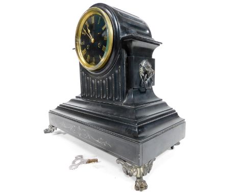 A Victorian black slate mantel clock, in architectural case, with lion mask handles, raised on hairy paw front feet, with 13c