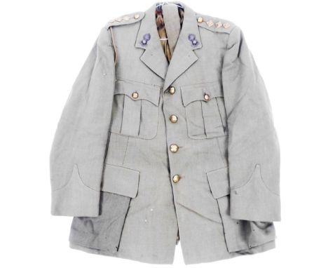 A 20thC army jacket, quarter length with buttons and shoulder epaulettes. 