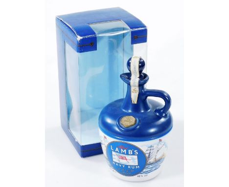 A Lambs Navy Rum ceramic decanter and stopper, with contents and outer packaging, 23cm H.
