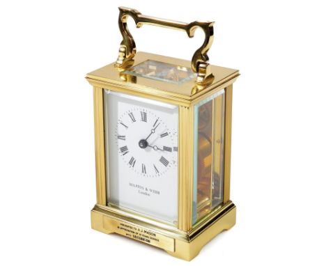 A 20thC Mappin &amp; Webb brass carriage clock, with swing handle, in five part glazed case with visible movement, 5cm Dia. m