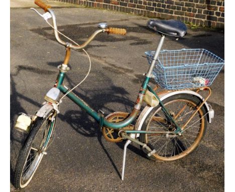 A ladies Toscana Deluxe vintage bicycle, with green frame, black saddle and blue basket, 102cm H.