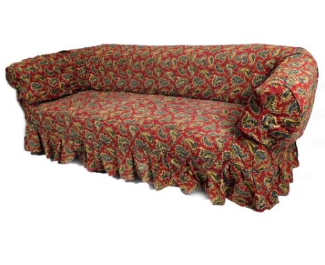 A Victorian mahogany framed Chesterfield sofa, in floral button back material, with shaped arms and inverted bun feet termina