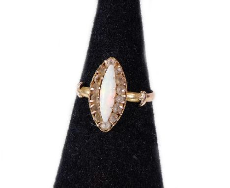 A 9ct gold opal dress ring, set with marquise shaped opal stone in claw setting, surrounded by white paste stones, in a diamo