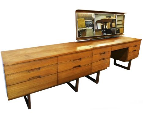 A vintage teak bedroom pair, comprising mirror back dressing table and dressing chest, of six short drawers on D end shaped l