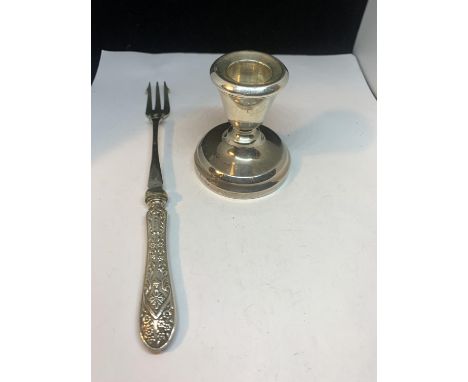 A HALLMARKED BIRMINGHAM CANDLESTICK AND A SILVER PLATED PICKLE FORK 