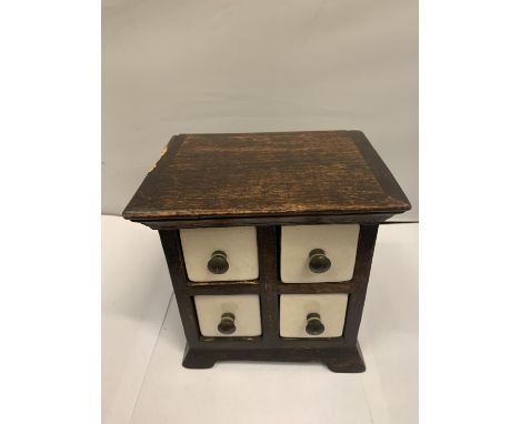 A MINATURE WOODEN CHEST WITH FOUR GLAZED CERAMIC DRAWERS 