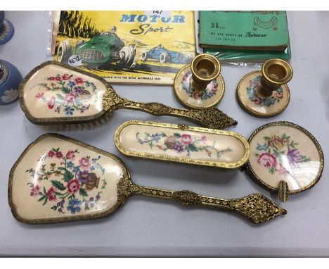 A VINTAGE SIX PIECE DRESSING TABLE SET TO INCLUDE A MIRROR, HAIRBRUSH, CLOTHES BRUSH , CANDLESTICKS AND TRINKET DISH 